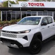 White Toyota HiLux dual cab outside a Toyota dealership